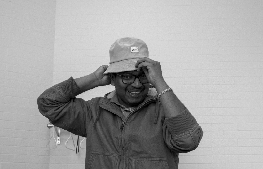 gabriel-ogulu-s7NkZtPRfmg-unsplash Person adjusting hat symbolizing attention to detail and professional services